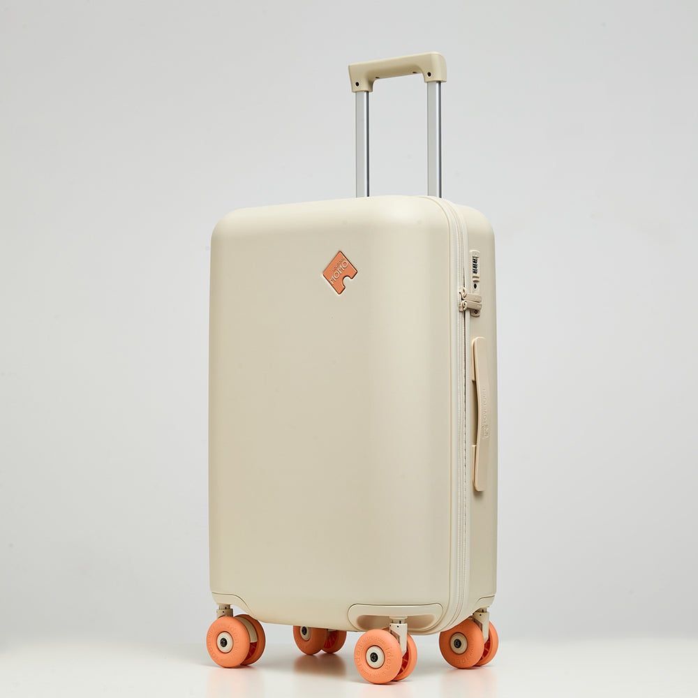 Lovetour cream white hardside luggage with contrast coral orange 3-inch donut wheels, 45-degree angle view showing TSA lock and side handle
