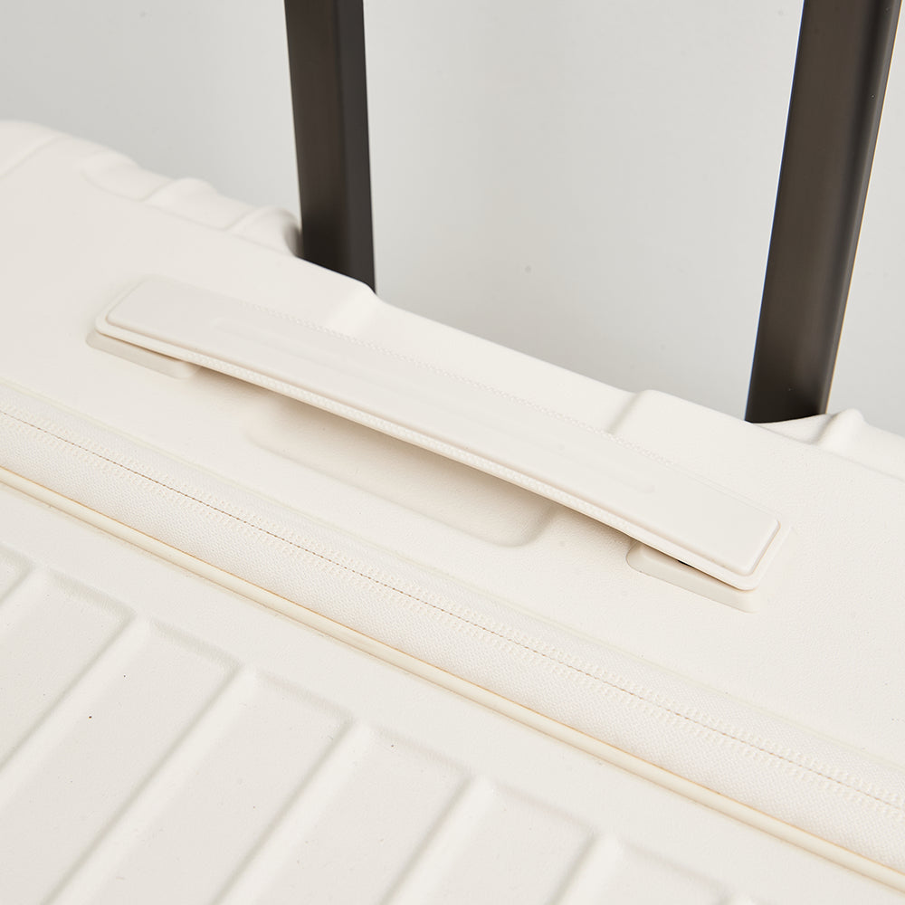 Close-up detail of the Lovetour off-white suitcase top grab handle and smooth-retracting trolley system
