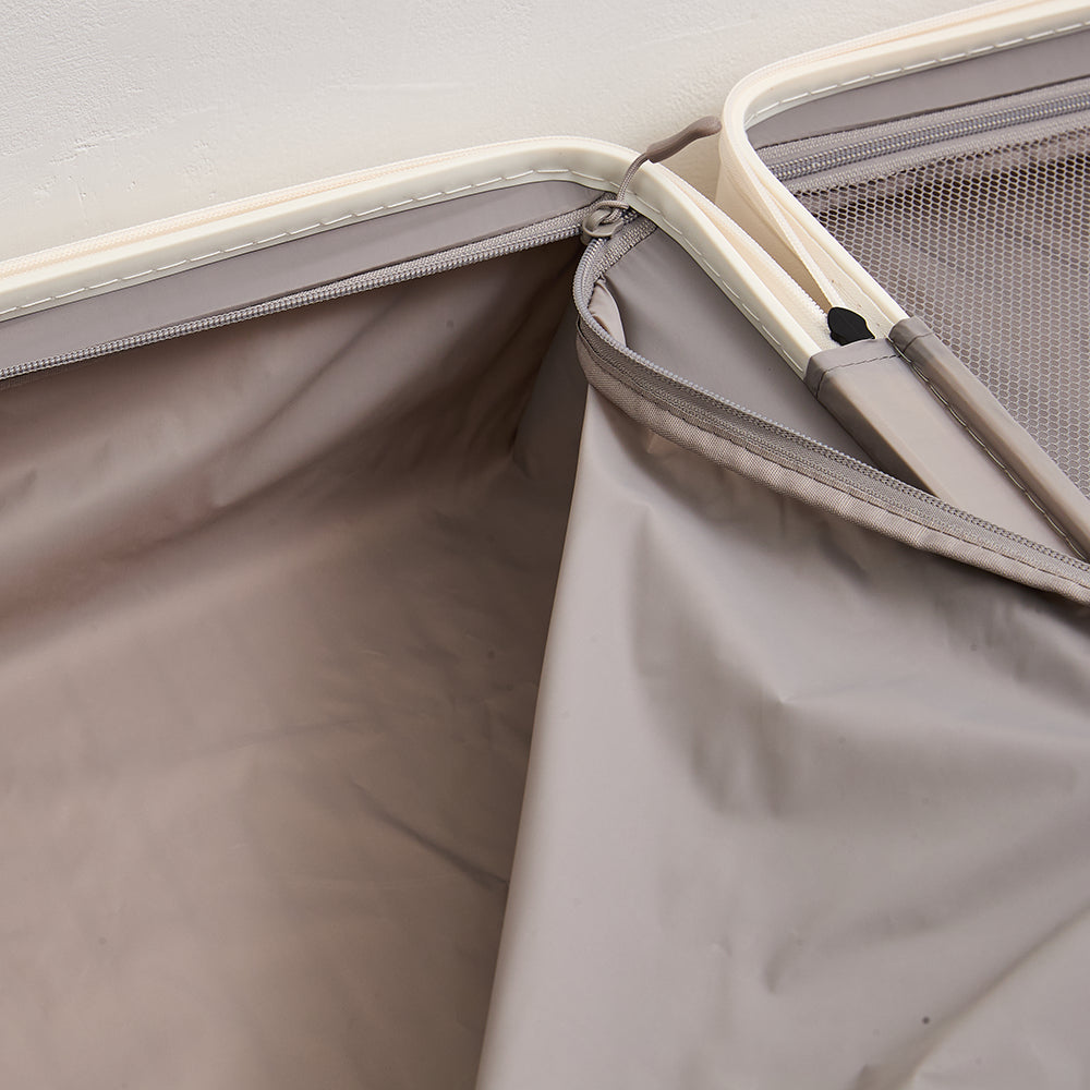 Close-up of the smooth gray inner lining fabric and high-quality zipper compartments inside the Lovetour white luggage